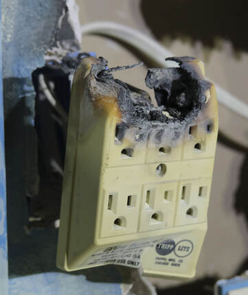 Picture of burnt out outlet from an electrical fire